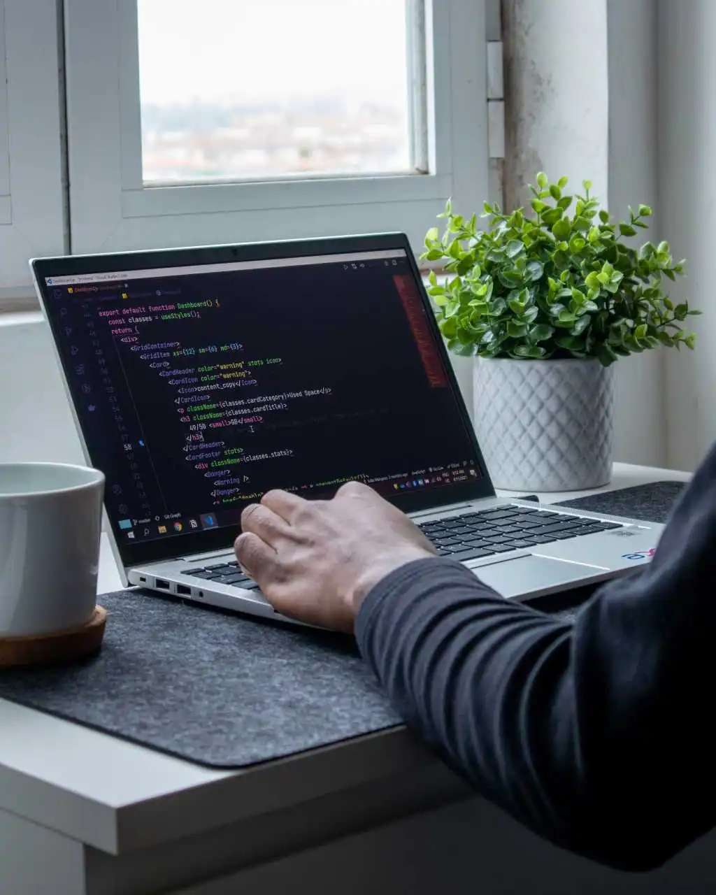 A laptop with a code editor open, showcasing web development work
