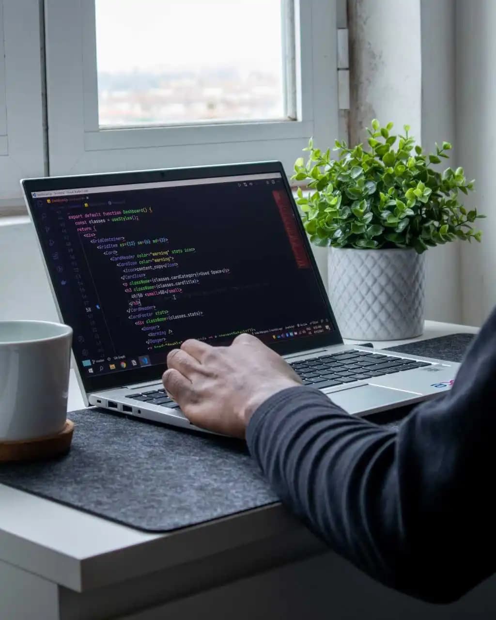 A laptop with a code editor open, showcasing web development work